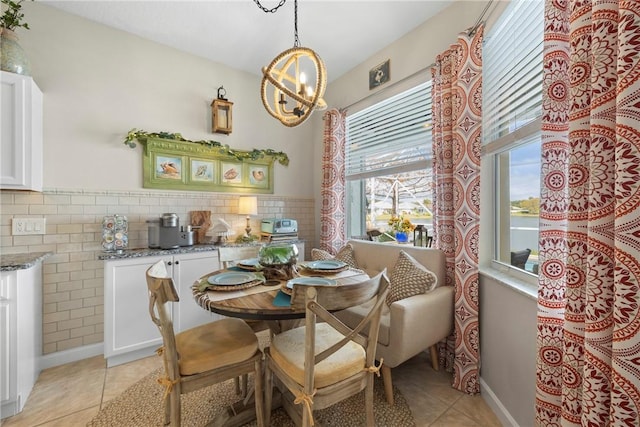 tiled dining space with a notable chandelier