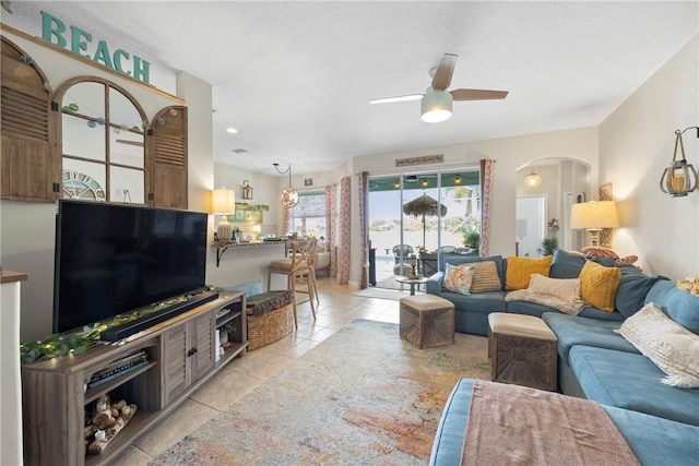 living room featuring ceiling fan and light tile patterned floors