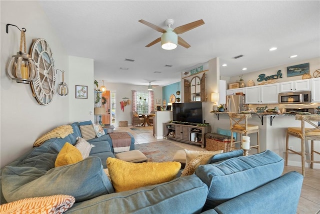 tiled living room with ceiling fan