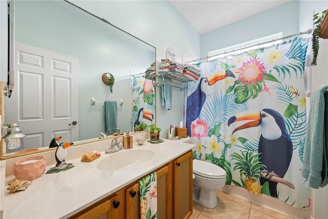 bathroom featuring toilet, tile patterned flooring, and vanity