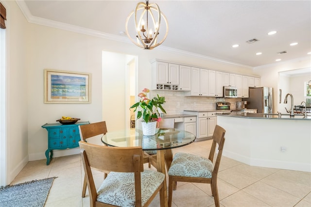 dining room with a chandelier, light tile patterned floors, and ornamental molding