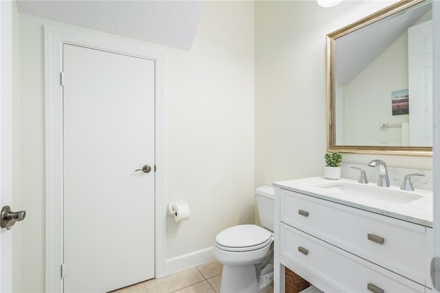 bathroom featuring tile patterned flooring, vanity, toilet, and lofted ceiling