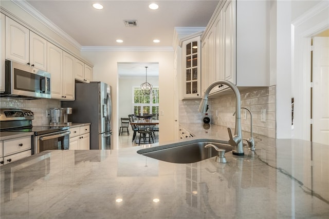 kitchen with stainless steel appliances, light stone counters, decorative backsplash, sink, and crown molding