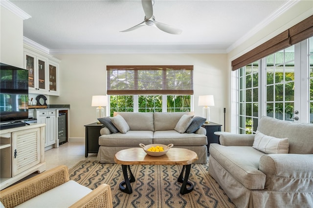 living room featuring ornamental molding, a healthy amount of sunlight, and wine cooler