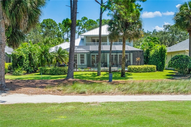 exterior space featuring a balcony and a lawn