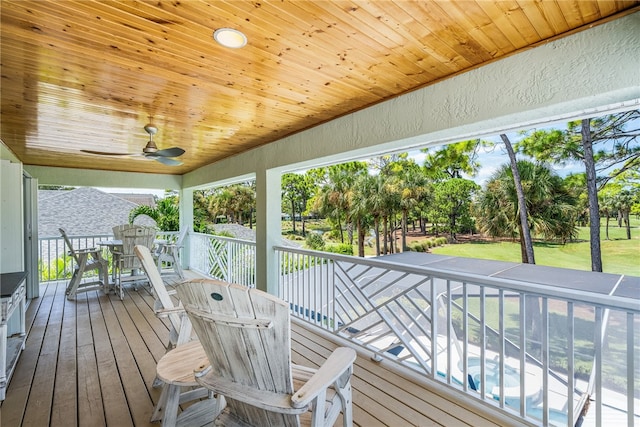 wooden deck featuring ceiling fan