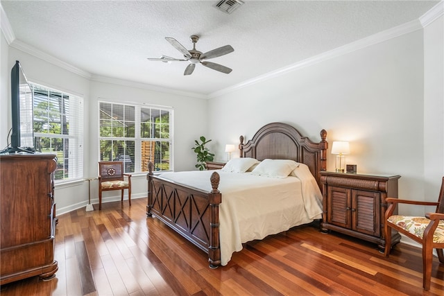 bedroom with a textured ceiling, multiple windows, dark hardwood / wood-style flooring, and ceiling fan