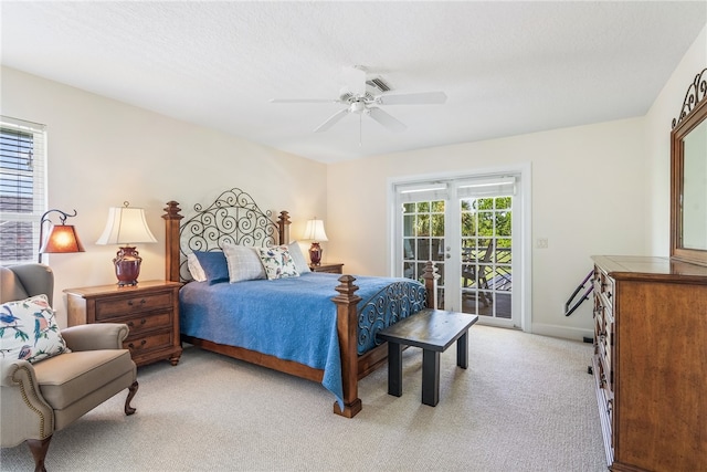 carpeted bedroom featuring access to exterior, a textured ceiling, and ceiling fan