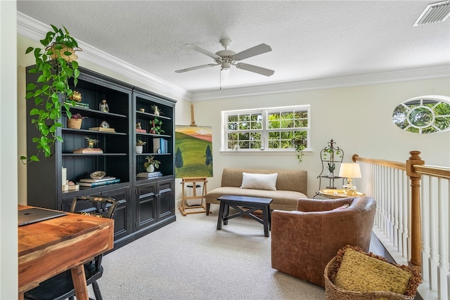 living area featuring carpet, a textured ceiling, ceiling fan, and crown molding