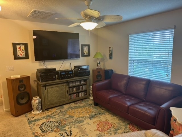 living room featuring ceiling fan and carpet flooring