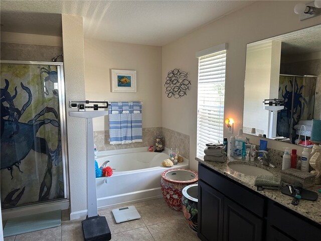 bathroom featuring independent shower and bath, vanity, a textured ceiling, and tile patterned flooring