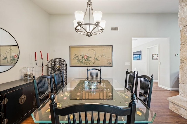 240 44th Ter SW, Vero Beach, FL 32968 - dining room with a chandelier, wood finished floors, and baseboards
