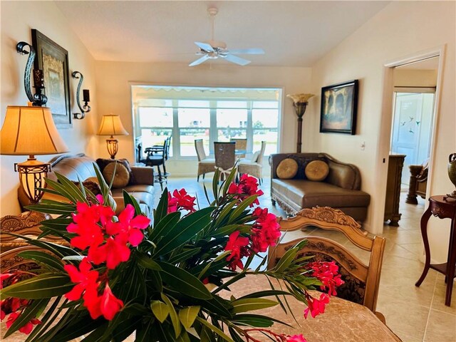 600 E Lake Jasmine Cir Unit 206, Vero Beach, FL 32962 - living room featuring light tile patterned flooring, ceiling fan, and vaulted ceiling
