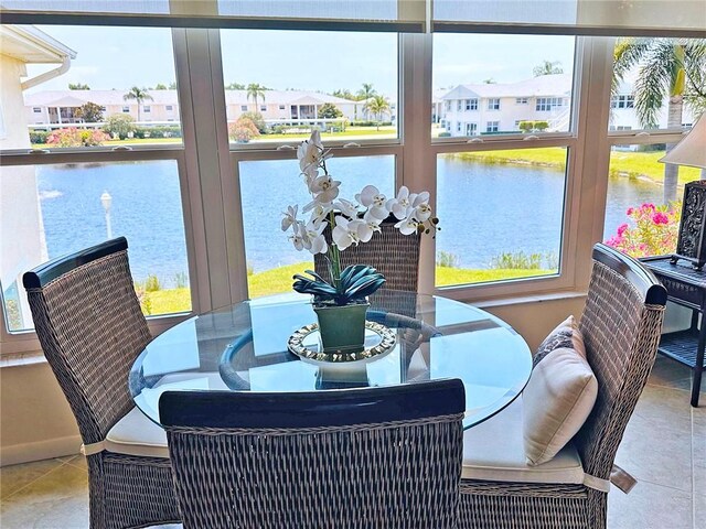 600 E Lake Jasmine Cir Unit 206, Vero Beach, FL 32962 - tiled dining room featuring healthy amount of natural light, a water view, and a residential view