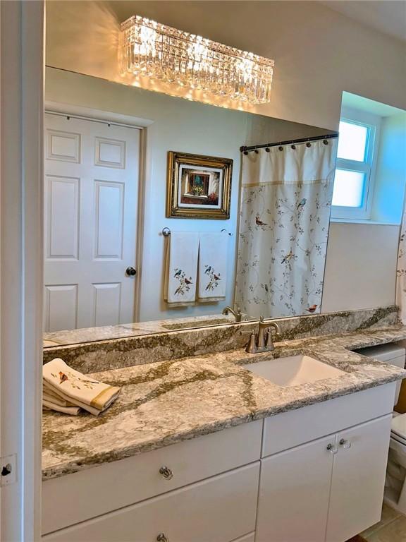600 E Lake Jasmine Cir Unit 206, Vero Beach, FL 32962 - bathroom featuring vanity, toilet, and curtained shower