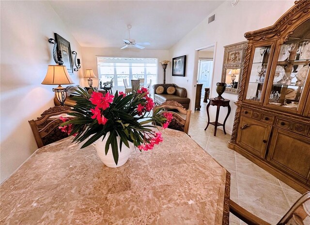 600 E Lake Jasmine Cir Unit 206, Vero Beach, FL 32962 - dining area with vaulted ceiling, ceiling fan, and light tile patterned floors