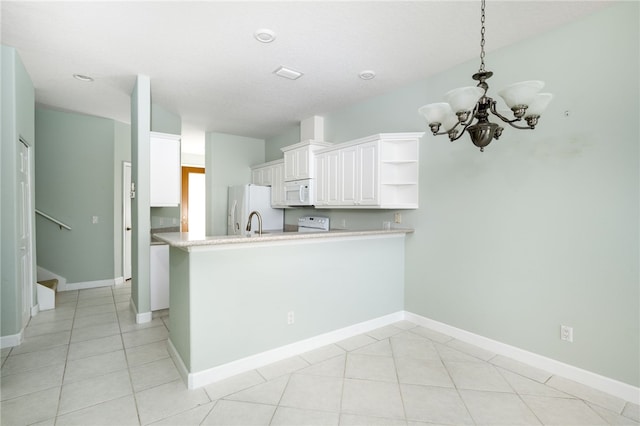 kitchen featuring kitchen peninsula, white appliances, an inviting chandelier, and white cabinetry