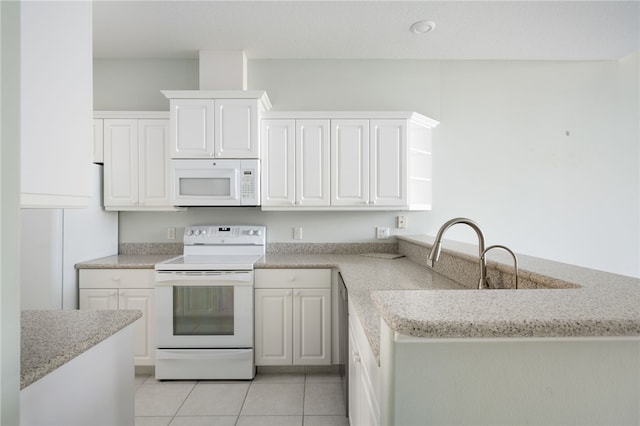 kitchen with kitchen peninsula, light tile patterned floors, white cabinets, and white appliances