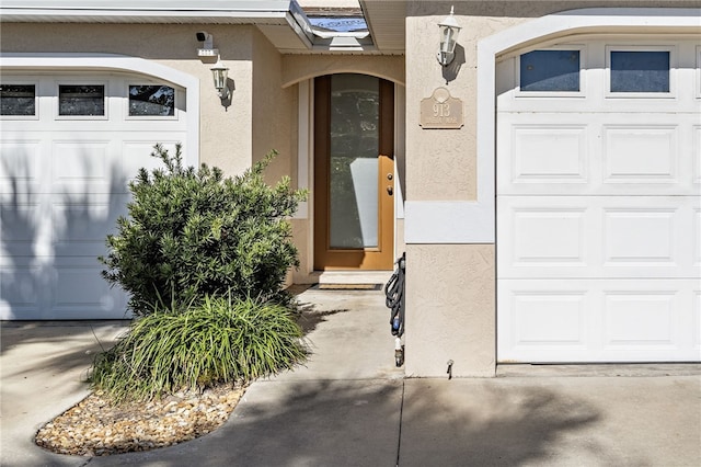 view of exterior entry with a garage