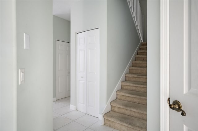 stairs featuring tile patterned flooring