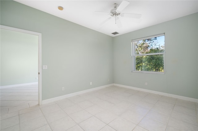 unfurnished room with ceiling fan and light tile patterned flooring