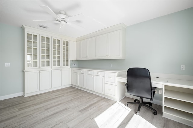 office with ceiling fan, light hardwood / wood-style flooring, and built in desk