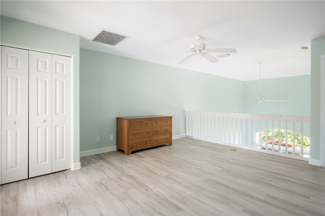 bedroom with ceiling fan, light hardwood / wood-style flooring, and a closet