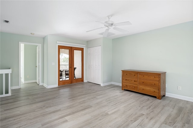 empty room with ceiling fan, french doors, and light hardwood / wood-style floors