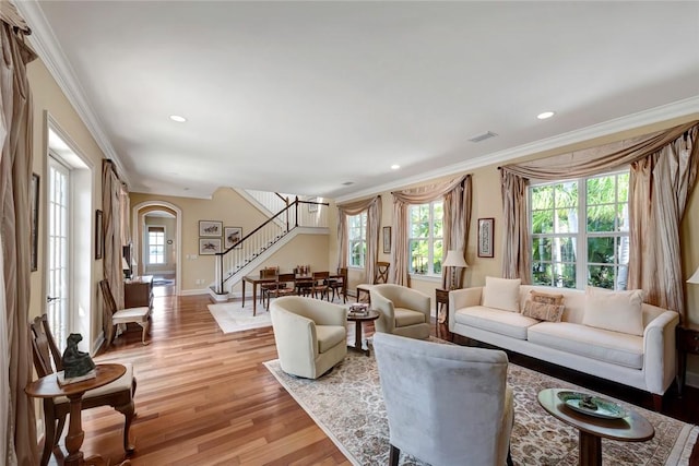 living room featuring light hardwood / wood-style floors and ornamental molding