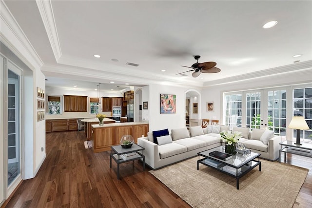 living room with french doors, a tray ceiling, ceiling fan, and ornamental molding