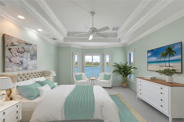 bedroom featuring a raised ceiling, ceiling fan, crown molding, and light carpet