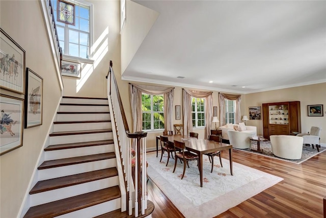 dining area with hardwood / wood-style flooring and crown molding