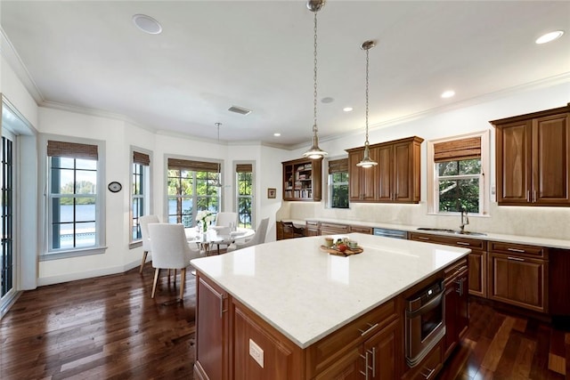 kitchen with decorative backsplash, pendant lighting, a center island, and dark hardwood / wood-style floors