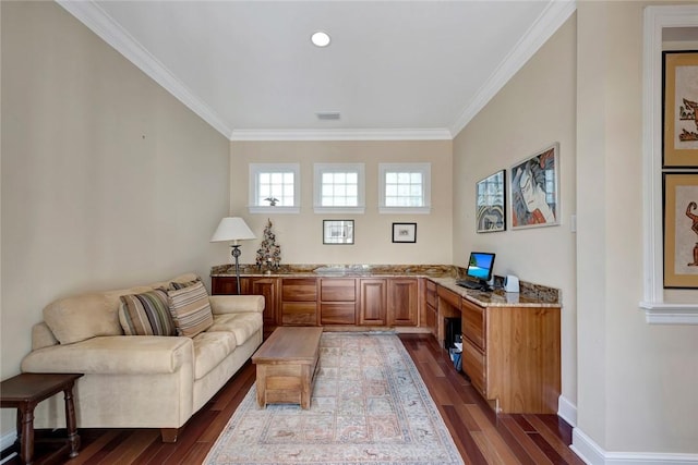 home office featuring built in desk, dark hardwood / wood-style floors, and ornamental molding