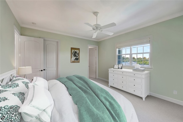 carpeted bedroom with a closet, ceiling fan, and ornamental molding