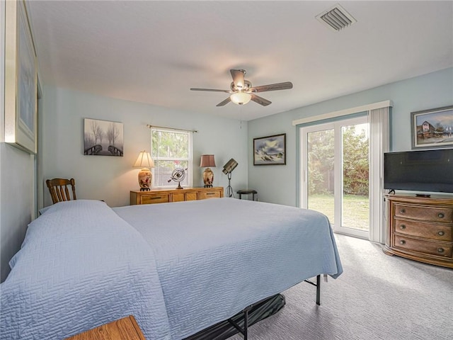 bedroom with light carpet, access to outside, visible vents, and ceiling fan