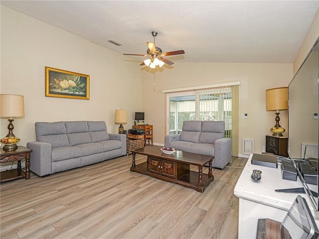 living area with light wood finished floors, lofted ceiling, visible vents, ceiling fan, and a textured ceiling