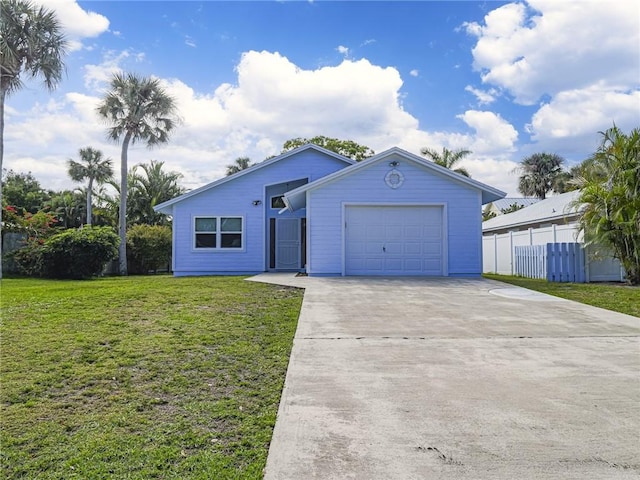 view of front of house with a front yard, driveway, an attached garage, and fence