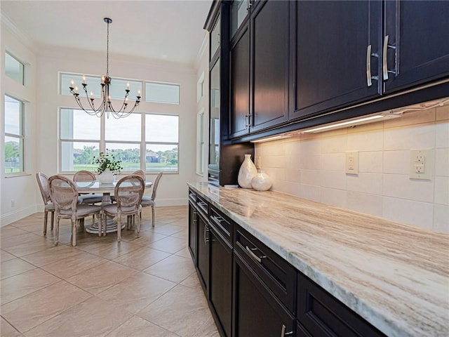 4520 Jacqueline Mnr, Vero Beach, FL 32968 - kitchen with a chandelier, crown molding, light tile patterned floors, decorative backsplash, and healthy amount of natural light
