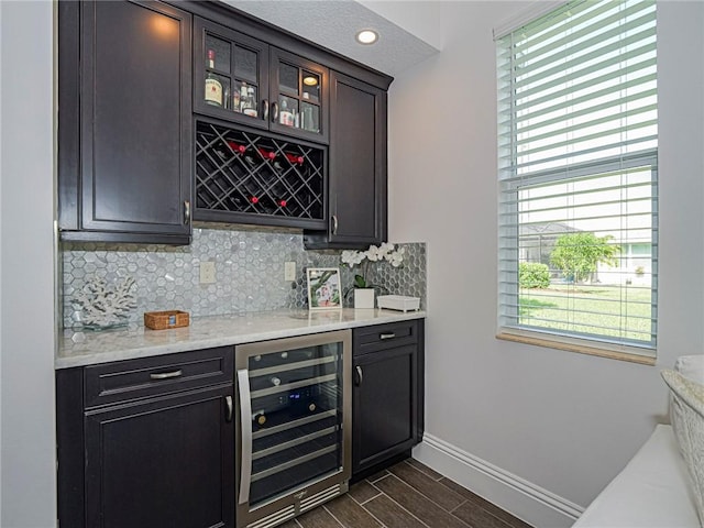 4520 Jacqueline Mnr, Vero Beach, FL 32968 - indoor dry bar featuring beverage cooler, decorative backsplash, and dark wood-style floors