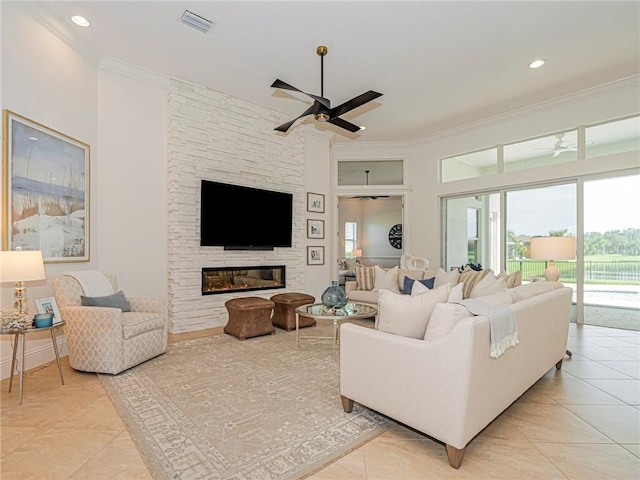 4520 Jacqueline Mnr, Vero Beach, FL 32968 - living area featuring ceiling fan, ornamental molding, light tile patterned flooring, a fireplace, and recessed lighting