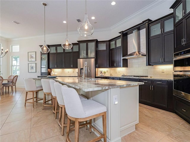 4520 Jacqueline Mnr, Vero Beach, FL 32968 - kitchen featuring wall chimney exhaust hood, ornamental molding, light tile patterned floors, tasteful backsplash, and recessed lighting