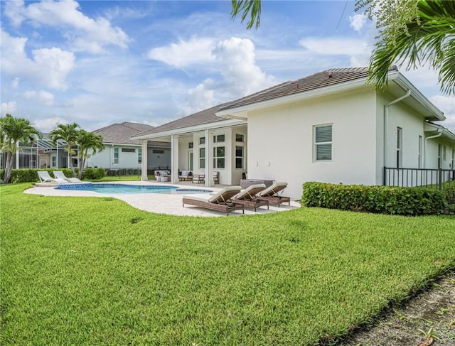 4520 Jacqueline Mnr, Vero Beach, FL 32968 - rear view of property featuring a patio, stucco siding, a yard, and an outdoor pool