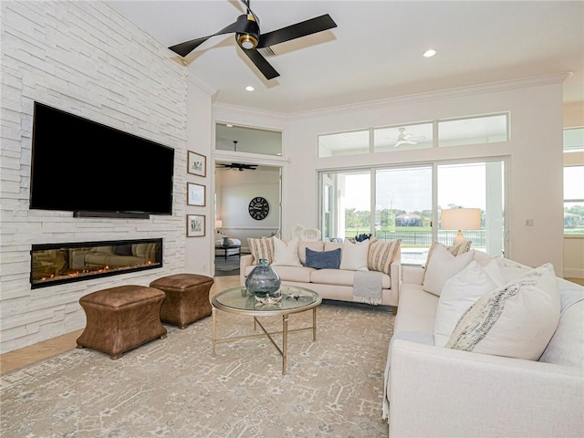 4520 Jacqueline Mnr, Vero Beach, FL 32968 - living room with ceiling fan, ornamental molding, and a stone fireplace