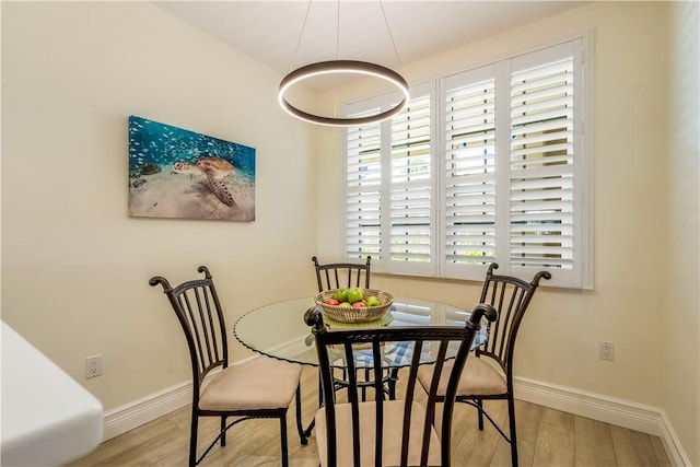 1510 Oak Harbor Blvd Unit 102, Vero Beach, FL 32967 - dining area with wood finished floors and baseboards