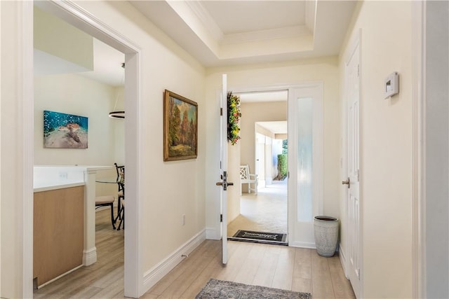1510 Oak Harbor Blvd Unit 102, Vero Beach, FL 32967 - foyer featuring light wood-style flooring, a raised ceiling, and ornamental molding