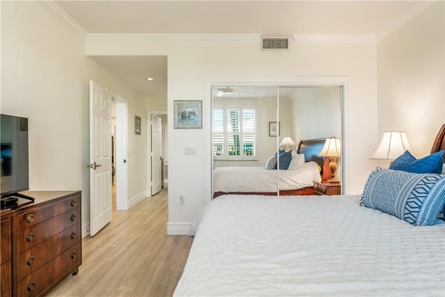 1510 Oak Harbor Blvd Unit 102, Vero Beach, FL 32967 - bedroom featuring light wood-style flooring, crown molding, a closet, and baseboards