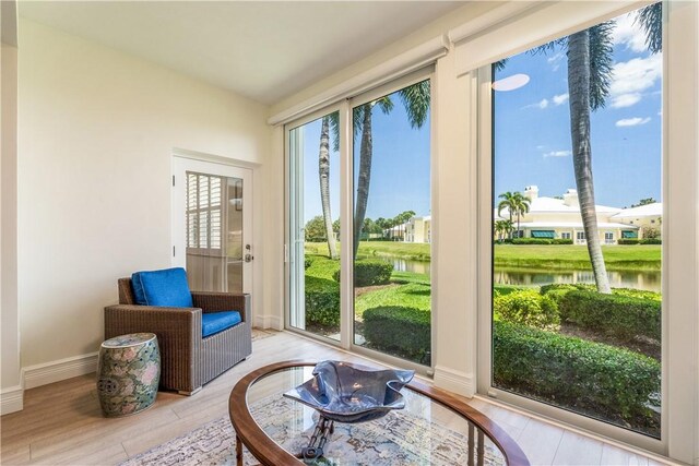 1510 Oak Harbor Blvd Unit 102, Vero Beach, FL 32967 - living area with a water view, wood finished floors, and baseboards