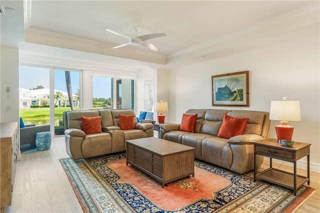 1510 Oak Harbor Blvd Unit 102, Vero Beach, FL 32967 - living room featuring a tray ceiling, light wood-type flooring, a ceiling fan, and crown molding