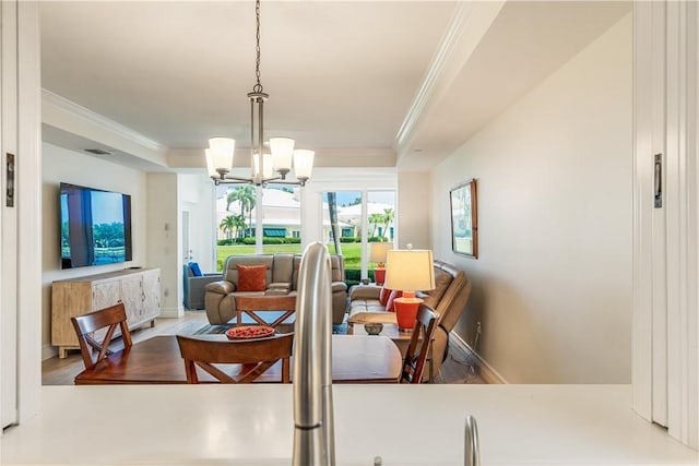 1510 Oak Harbor Blvd Unit 102, Vero Beach, FL 32967 - dining room with ornamental molding, a chandelier, wood finished floors, baseboards, and a tray ceiling